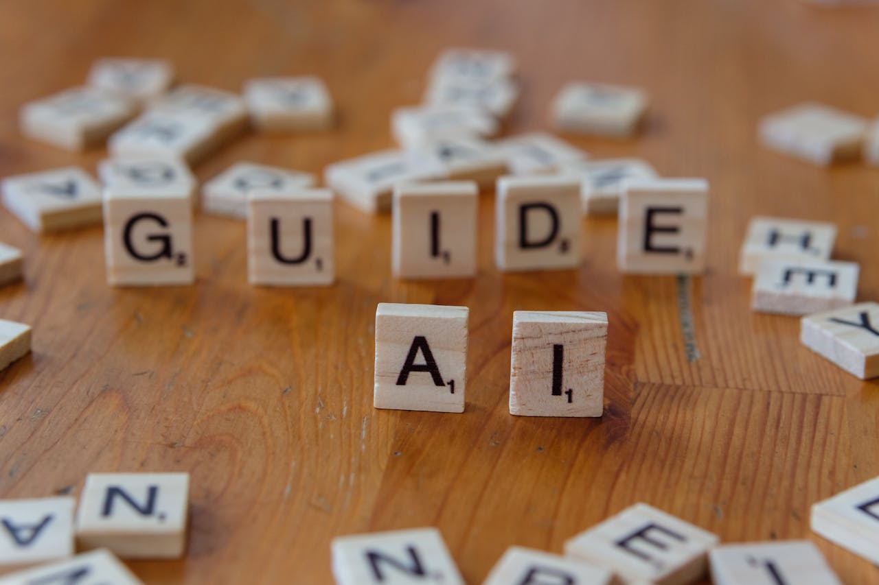 services-04 Scrabble letters spelling 'GUIDE' and 'AI' on a wooden surface, suggesting direction and technology.
